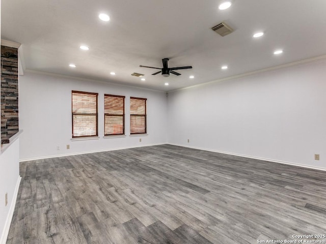 unfurnished living room with ceiling fan, visible vents, wood finished floors, and ornamental molding