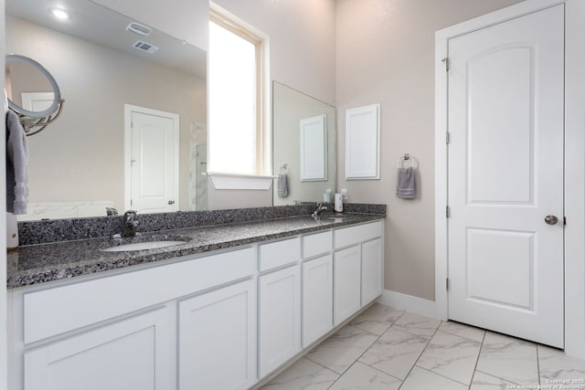 full bath with marble finish floor, visible vents, a sink, and double vanity