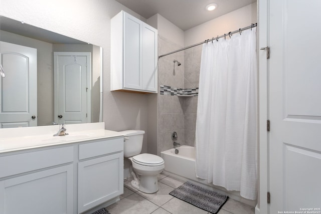 full bathroom featuring tile patterned flooring, vanity, toilet, and shower / bath combo with shower curtain