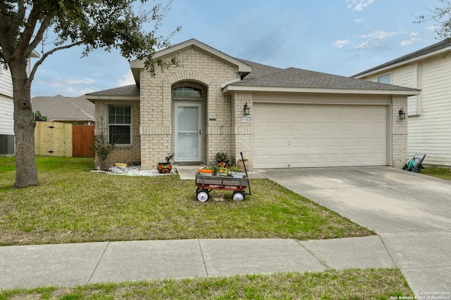 ranch-style home featuring concrete driveway, roof with shingles, an attached garage, a front lawn, and brick siding