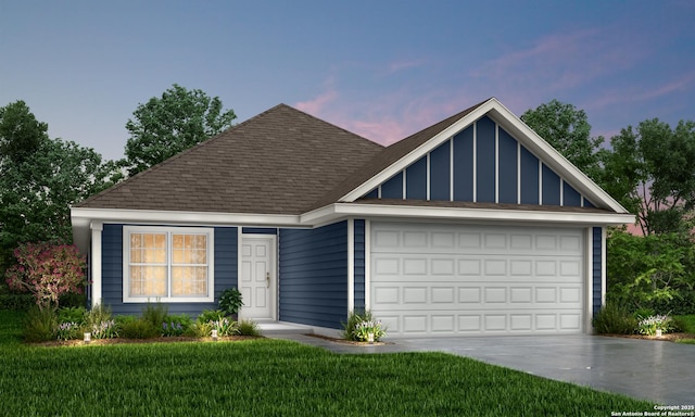 view of front of home featuring a garage, driveway, a shingled roof, and a lawn