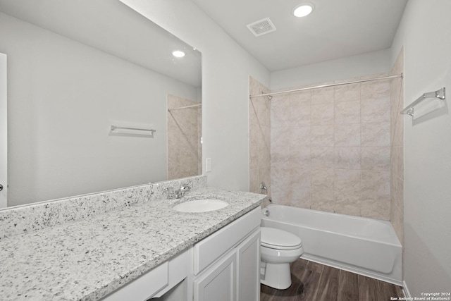 full bath with shower / washtub combination, visible vents, toilet, vanity, and wood finished floors