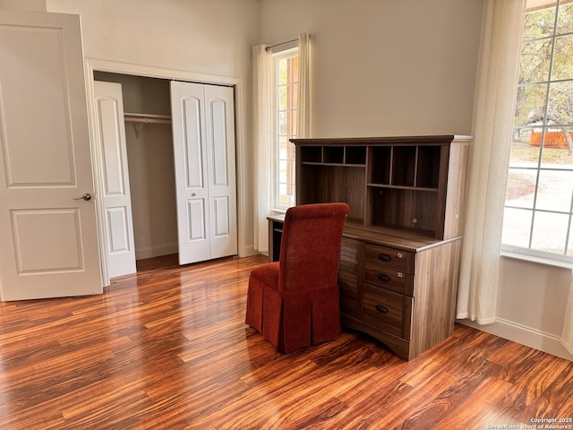 office space with dark wood-style floors and baseboards