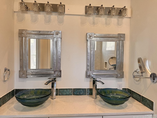 full bathroom featuring a sink and double vanity