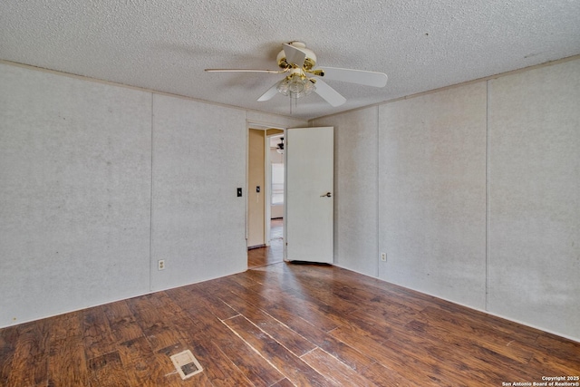 225 County Road 3821, San Antonio, TX 78253 - spare room featuring a textured ceiling, visible vents, dark wood finished floors, and a ceiling fan