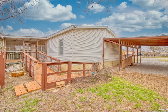 225 County Road 3821, San Antonio, TX 78253 - view of side of home with an attached carport and a wooden deck