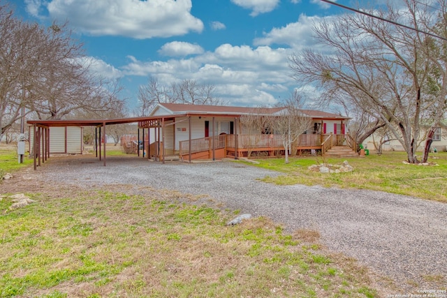 225 County Road 3821, San Antonio, TX 78253 - view of front of home with a front yard, covered porch, an attached carport, and gravel driveway