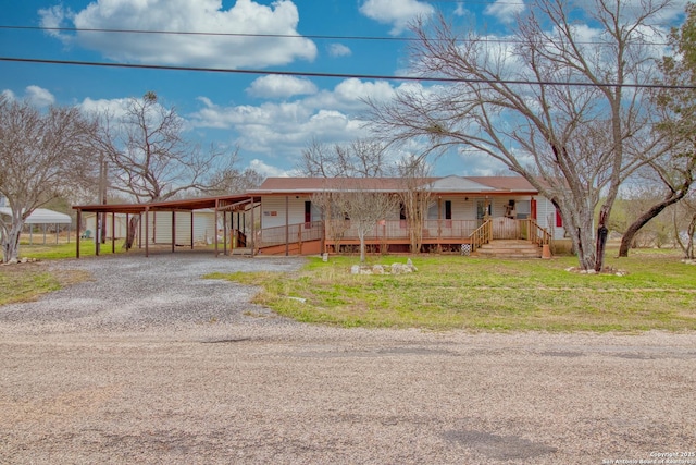 225 County Road 3821, San Antonio, TX 78253 - view of front facade with covered porch, a front lawn, and gravel driveway