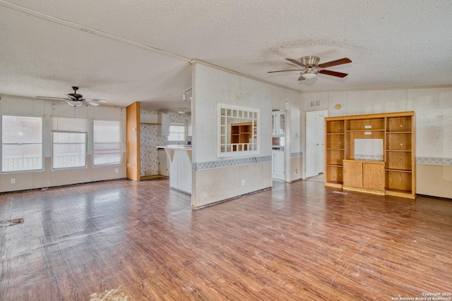 225 County Road 3821, San Antonio, TX 78253 - unfurnished living room featuring ceiling fan, a textured ceiling, and wood finished floors