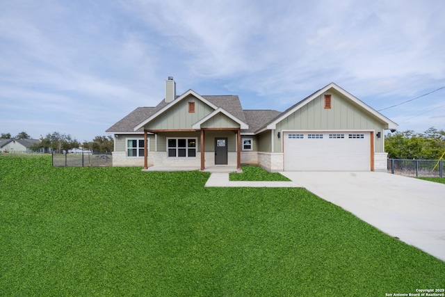 craftsman inspired home with a garage, driveway, a chimney, and a front yard