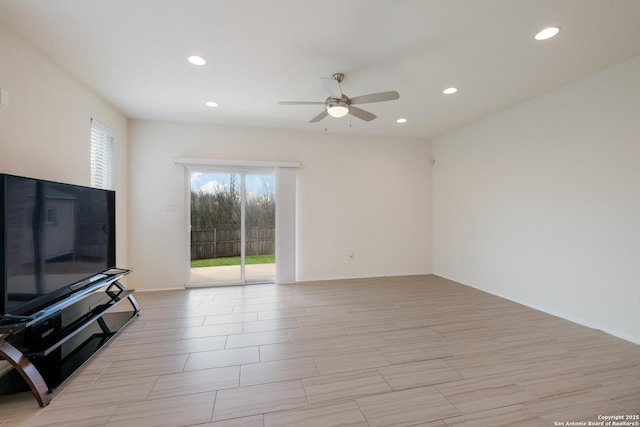 living room with baseboards, a ceiling fan, and recessed lighting