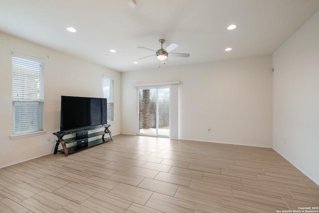 living room with a ceiling fan, recessed lighting, and baseboards