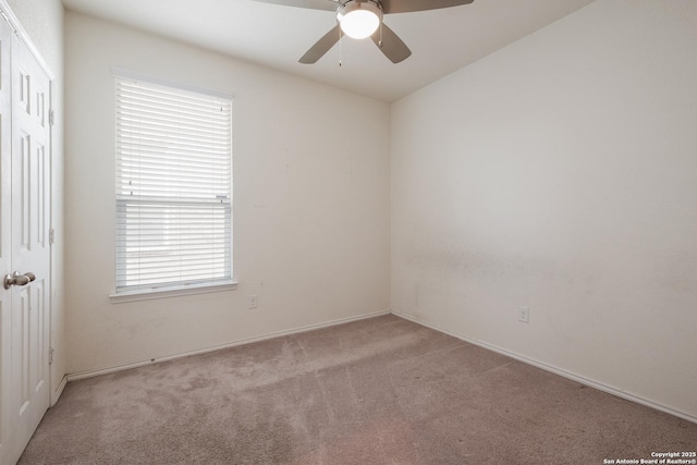 empty room featuring light carpet and ceiling fan