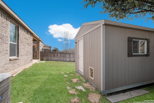 exterior space with cooling unit, an outdoor structure, a storage shed, and fence