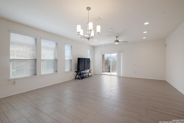 unfurnished living room with light wood-type flooring, ceiling fan with notable chandelier, and recessed lighting