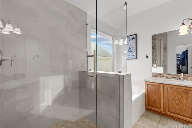 full bath with a garden tub, a stall shower, a walk in closet, and tile patterned floors