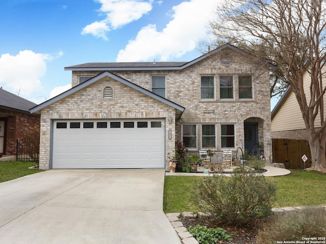 traditional home featuring a garage, a front lawn, concrete driveway, and brick siding