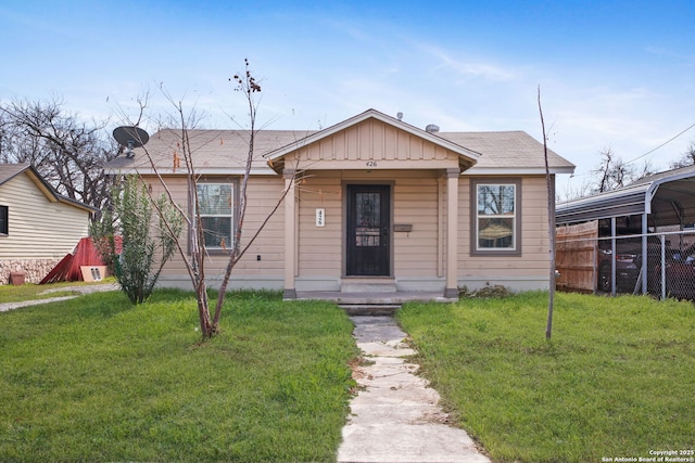 bungalow featuring fence, board and batten siding, and a front yard