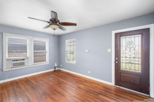 entrance foyer featuring dark wood-type flooring, cooling unit, ceiling fan, and baseboards