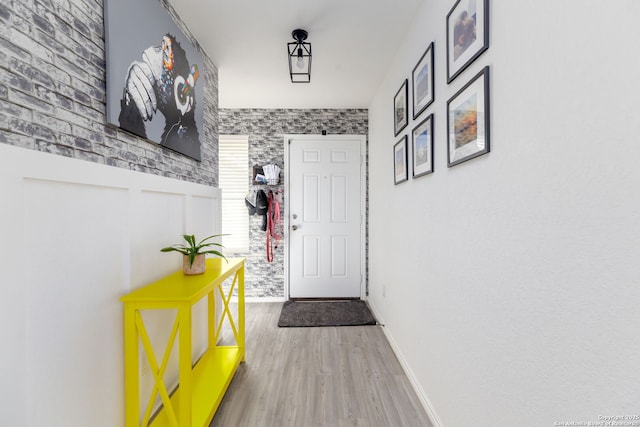 entryway featuring baseboards and light wood-style floors