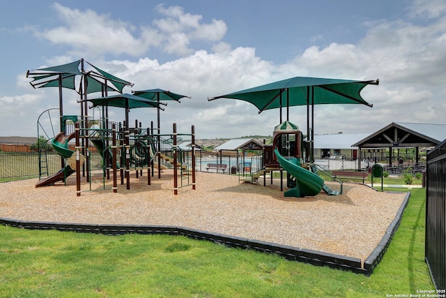 communal playground with a lawn and fence