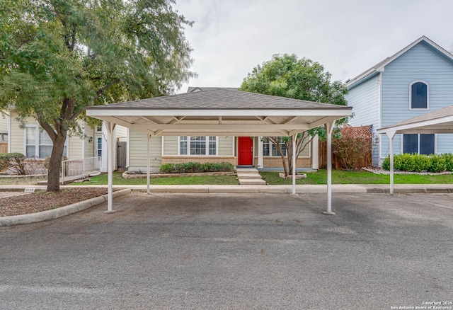 view of front of property featuring entry steps, brick siding, a shingled roof, fence, and covered and uncovered parking