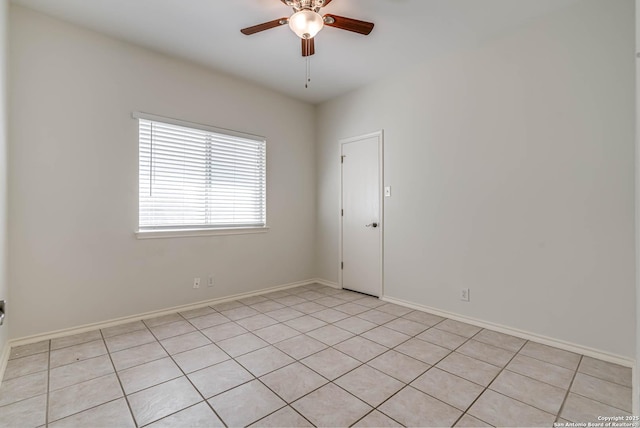 unfurnished room featuring ceiling fan and baseboards