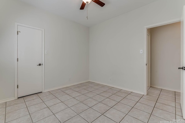 spare room with ceiling fan and baseboards