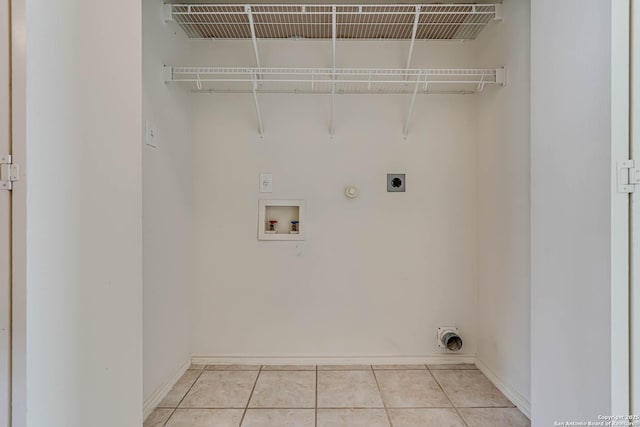 washroom featuring light tile patterned floors, hookup for a washing machine, gas dryer hookup, electric dryer hookup, and baseboards