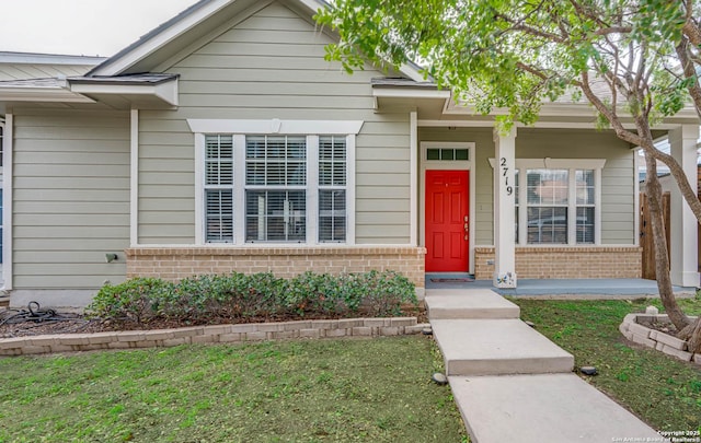 view of front of property with a front yard and brick siding