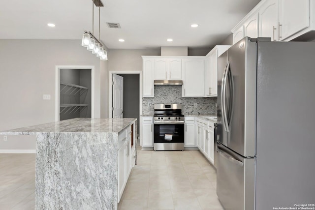 kitchen featuring pendant lighting, visible vents, appliances with stainless steel finishes, white cabinetry, and a kitchen island