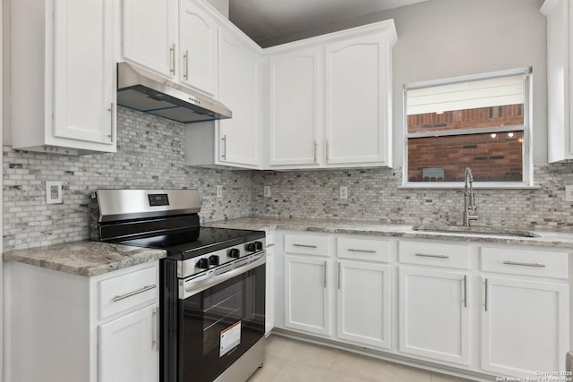 kitchen with white cabinets, light stone countertops, stainless steel electric range, under cabinet range hood, and a sink