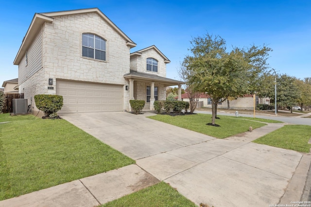 traditional home with driveway, a garage, stone siding, cooling unit, and a front yard