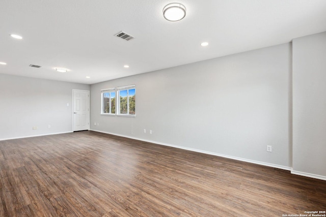 spare room featuring recessed lighting, visible vents, dark wood finished floors, and baseboards