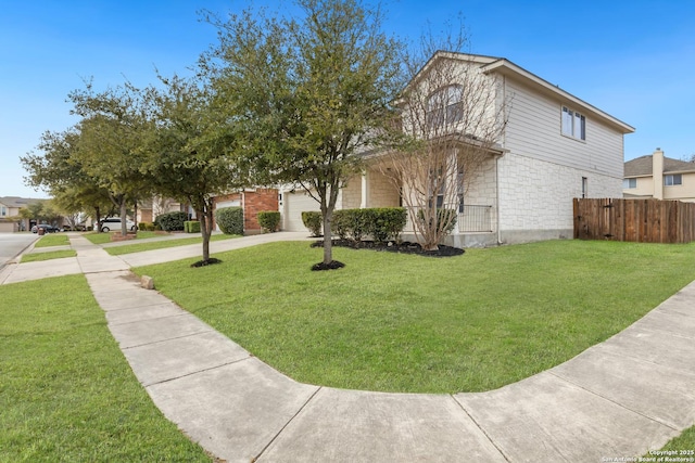 view of property exterior featuring brick siding, a lawn, driveway, and fence