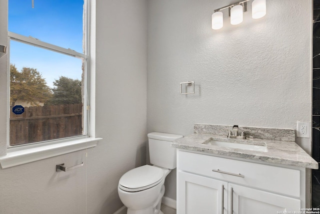 half bathroom with vanity and toilet