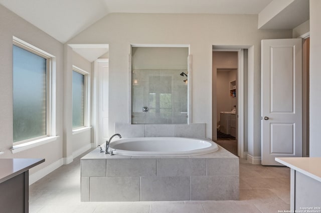 full bathroom with tiled shower, lofted ceiling, tile patterned floors, a garden tub, and vanity