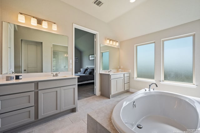 bathroom with visible vents, ensuite bath, a sink, vaulted ceiling, and two vanities