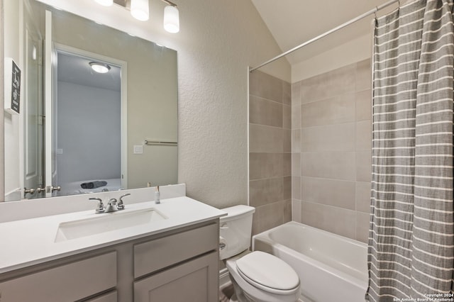 bathroom with toilet, a textured wall, shower / bath combination with curtain, and vanity