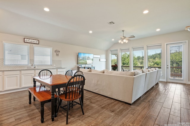 dining space with light wood finished floors, visible vents, lofted ceiling, ceiling fan, and recessed lighting