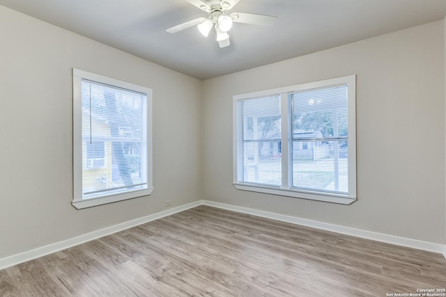 empty room with light wood-style flooring, baseboards, and ceiling fan