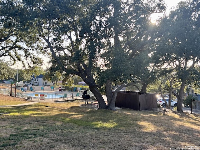 view of yard with fence and a community pool