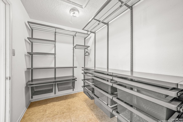 spacious closet featuring light tile patterned floors