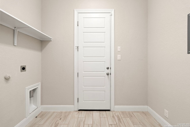 laundry room featuring wood finish floors, laundry area, hookup for an electric dryer, and baseboards