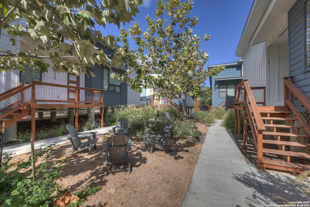 view of yard with an outdoor fire pit and stairs