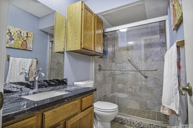 full bath with a stall shower, vanity, and toilet