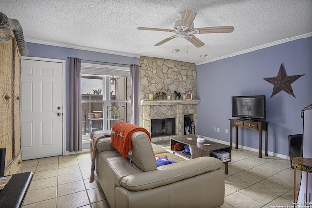 living room with a fireplace, ornamental molding, a ceiling fan, light tile patterned flooring, and a textured ceiling