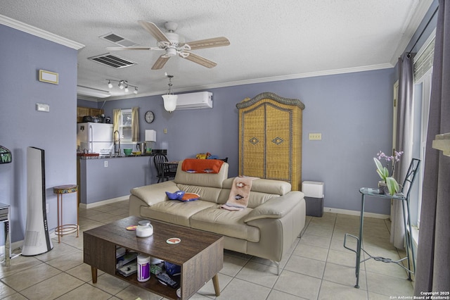 living area featuring a wall unit AC, crown molding, light tile patterned floors, visible vents, and a textured ceiling