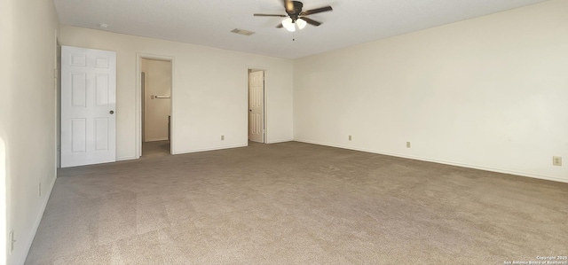 spare room with visible vents, dark carpet, ceiling fan, and baseboards