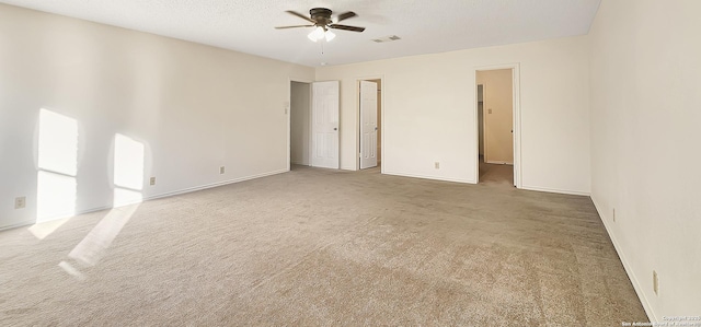 spare room featuring baseboards, visible vents, a ceiling fan, a textured ceiling, and carpet floors